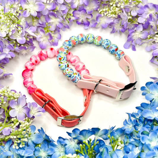 Colorful beaded dog collar and leash on a white background with flowers