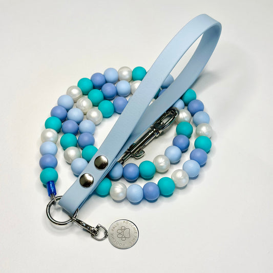 Beaded lanyard with a light blue strap and metal clip on a white background