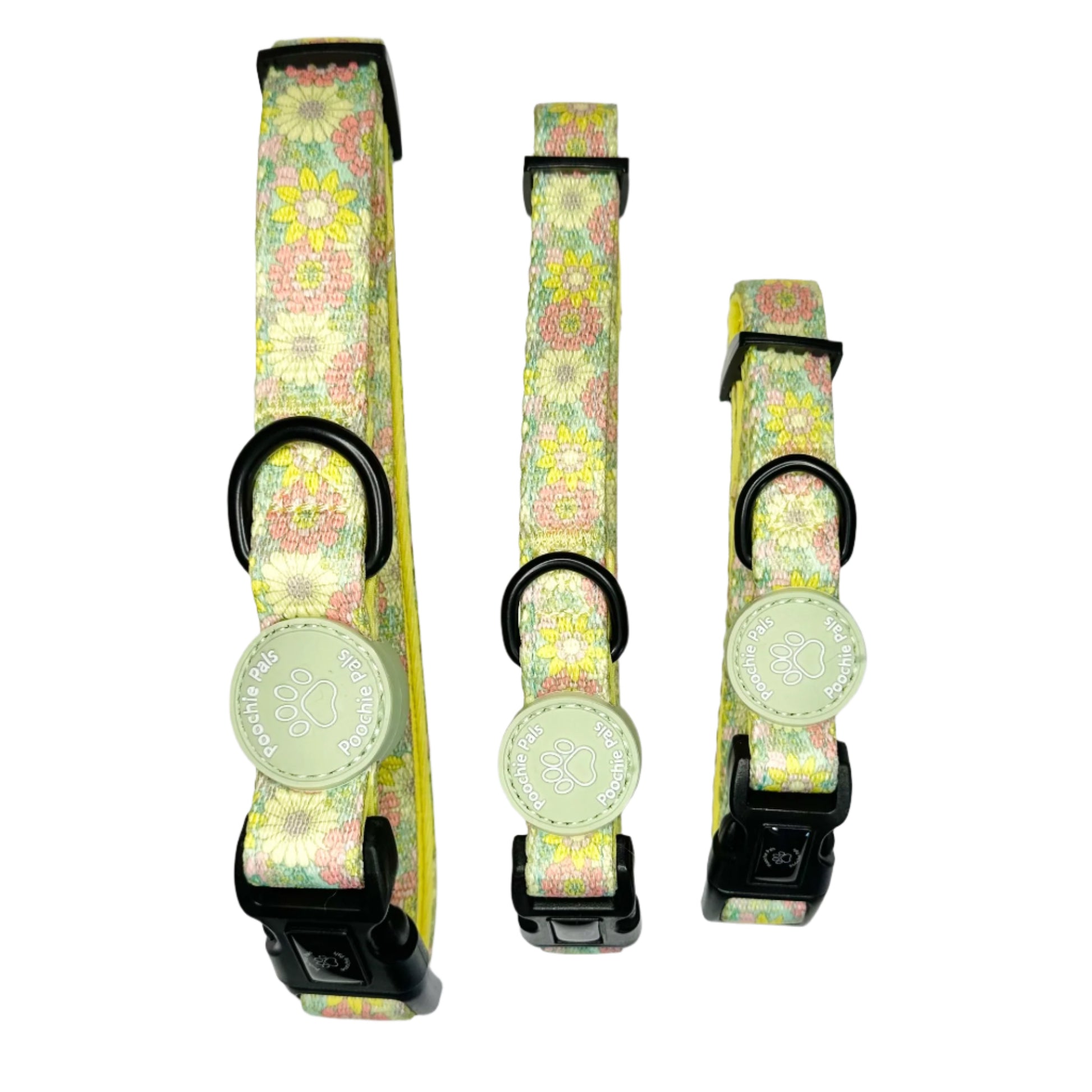 Three floral-patterned dog collars with black buckles on a white background