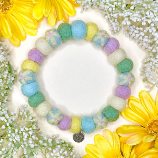 Colorful beaded bracelet on a bed of yellow and white flowers